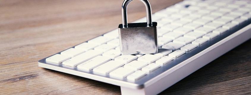 a computer keyboard with a padlock on top of it
